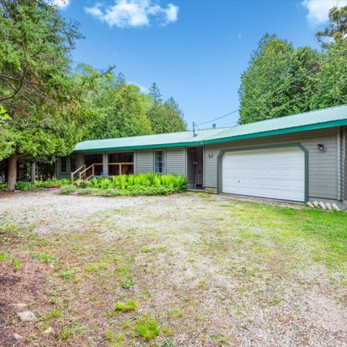 Spacious gravel driveway and attached garage make parking easy for your whole group. Set back from the road and hugged by evergreens, privacy and peace come standard.