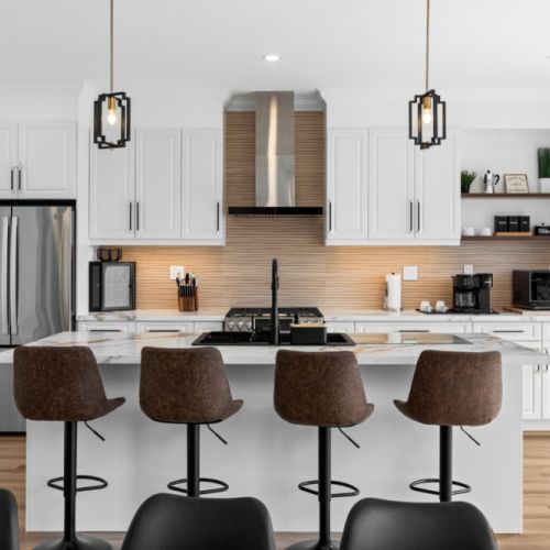 Gather around the spacious island in the fully equipped modern kitchen.