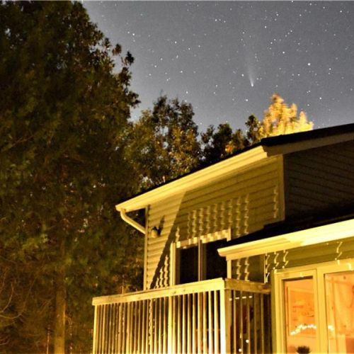Peaceful evenings at the cottage—enjoy quiet nights under the stars from the warmly lit deck.