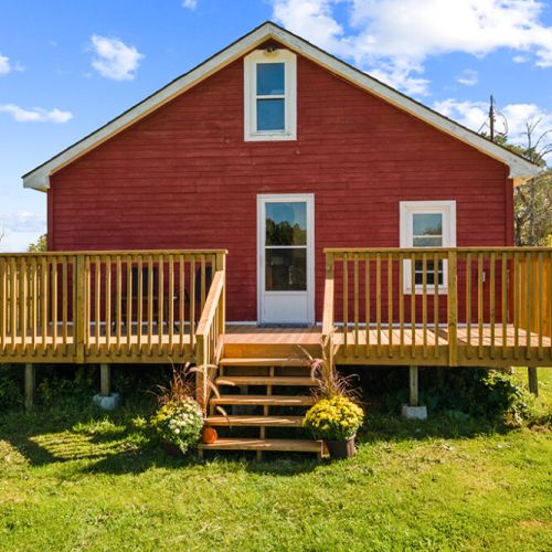 The spacious deck provides easy access between the farmhouse and the beautiful outdoor surroundings.