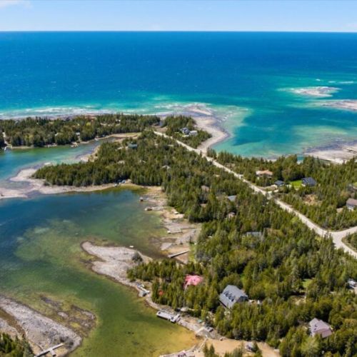 Breathtaking aerial view of Bradley Harbour’s crystal-clear waters, rugged shoreline, and peaceful natural surroundings.