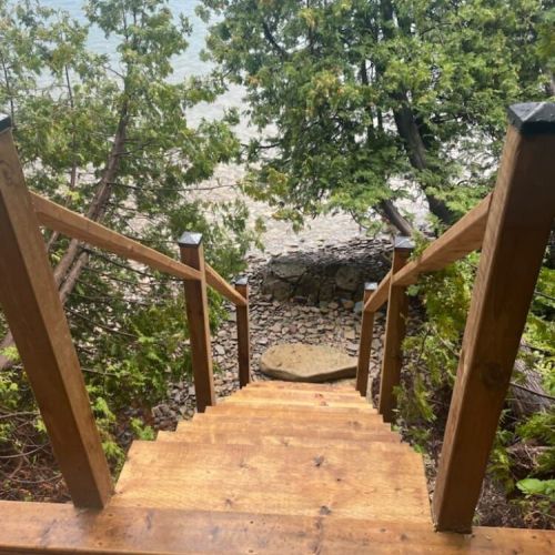 Private stairway access leading down to the crystal-clear waters of Colpoys Bay.