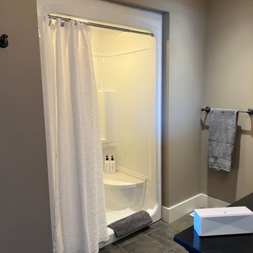Modern bathroom with a sleek shower, minimalist design, and neutral tones—offering a clean and inviting space.