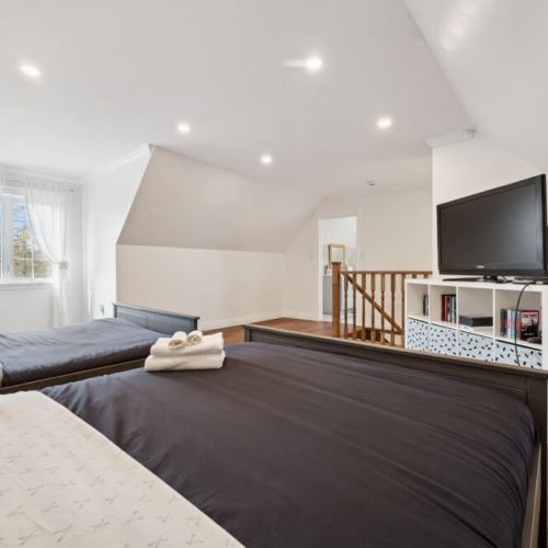 Bright and airy loft space with two comfortable beds—perfect for families, kids, or extra guests.