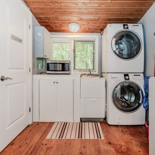 A full laundry area with washer, dryer, microwave, and sink offers convenience for week-long stays and family getaways.