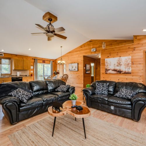 A view of the living room and kitchen, showcasing the spacious and airy design of the cottage.