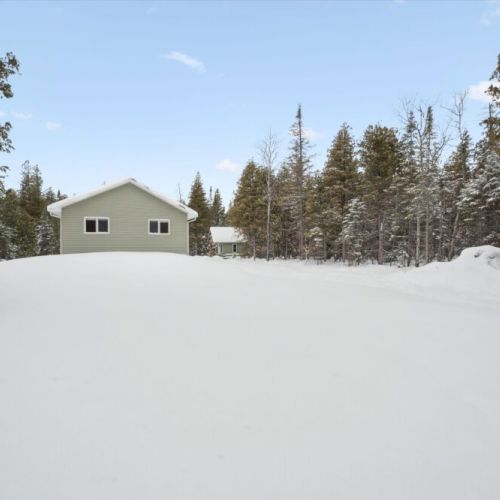 Expansive open yard offering plenty of space to play, relax, or enjoy the peaceful natural setting in every season.