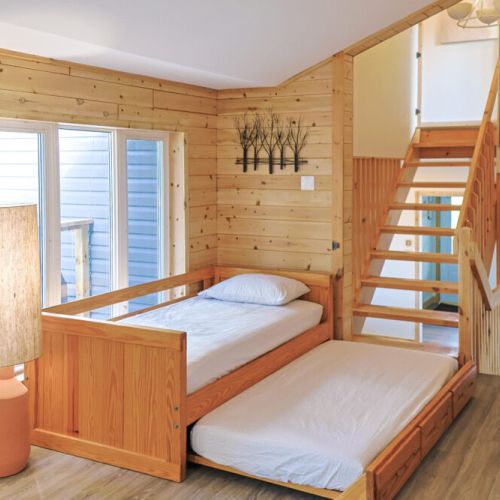 This living room is designed with both families and accessibility in mind. The built-in bed offers a comfortable and safe sleeping option for kids, while also providing a convenient and accessible sleeping arrangement for guests with mobility challenges.