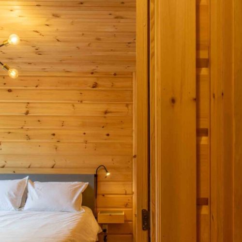 Warm wood tones and soft lighting create a serene atmosphere for restful nights.