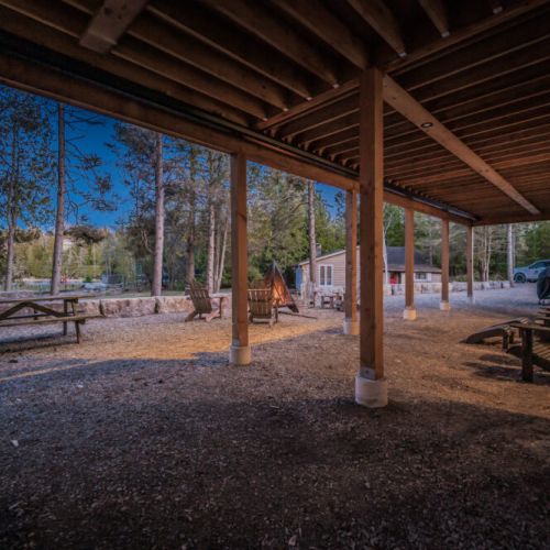 Relax under the covered patio at this peaceful lakeside vacation rental—perfect for outdoor lounging, evening bonfires, and enjoying the tranquil Ontario cottage country atmosphere.