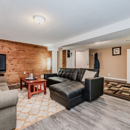 Our entertainment space is perfect for watching movies or playing games, with plenty of seating and rustic charm."