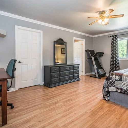 The Master bedroom features a dedicated work area, ensuite bathroom, and a treadmill. All linens and towels are supplied.