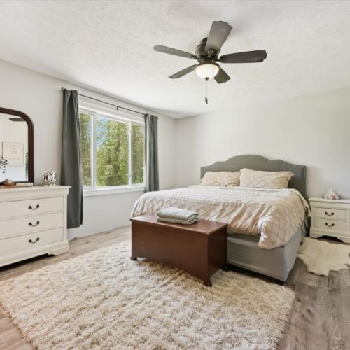 Bedroom 1: Comfortable bedroom with large windows, soft lighting, and peaceful views.