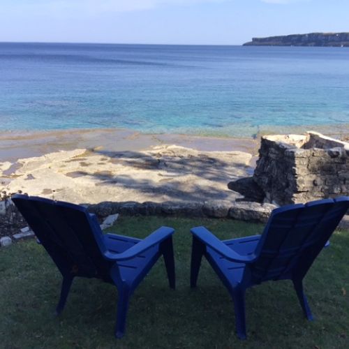 Adirondack chairs overlooking the bay, perfect for quiet moments.