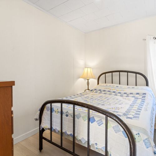 The second main-floor bedroom offers a cozy and private space to relax and recharge.