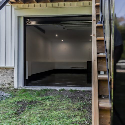 Ground level loft room with a wide open garage style door for indoor outdoor fun.