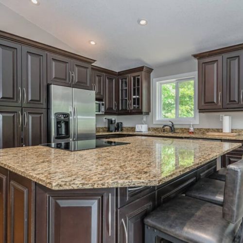 The large kitchen island with bar stools provides a great place to entertain.