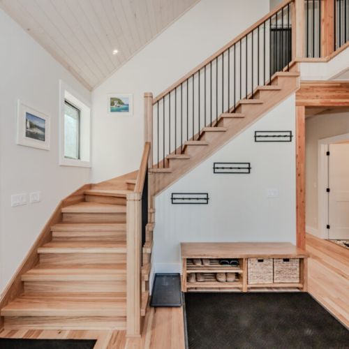Step into this beautifully designed vacation rental featuring a welcoming entryway with natural wood finishes, ample storage, and a cozy cabin vibe—perfect for your next nature escape or cottage retreat.