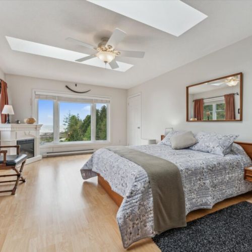 Master bedroom with lake views & fireplace – A luxurious space with king bed, panoramic views, and elegant comfort.