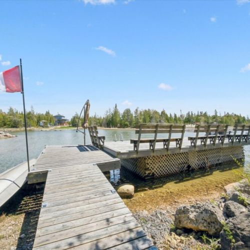 Private waterfront dock ideal for swimming, launching kayaks, or enjoying quiet mornings by the lake.