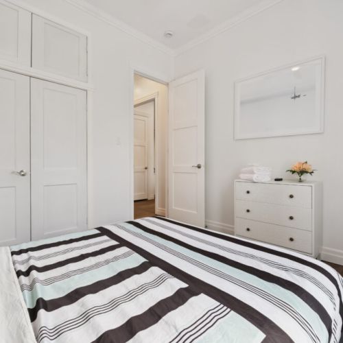 Relax in a comfortable bedroom featuring soft linens, ample storage, and a peaceful atmosphere.