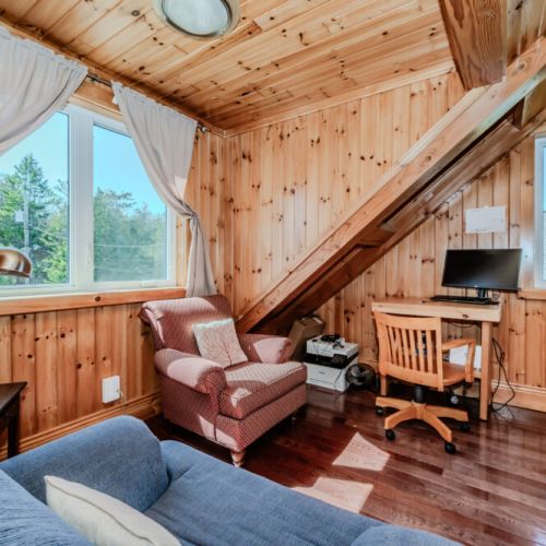 Charming upper-level workspace with natural light and forest views—perfect for remote work or writing during your nature escape.