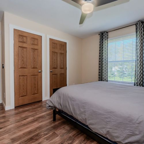 A peaceful retreat, the master bedroom offers comfort and simplicity, with ample closet space and windows that let in plenty of natural light.