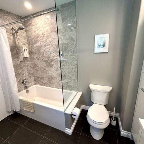 Clean lines and contemporary finishes—this modern bathroom features a sleek glass shower and stylish design throughout.