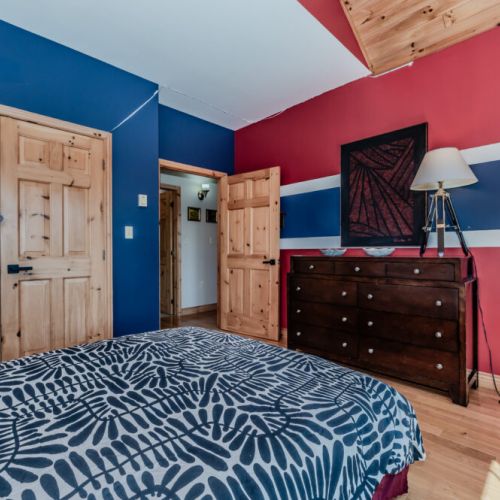 Chic and cozy bedroom featuring vibrant tones and ample storage—ideal for extended stays or weekend getaways.