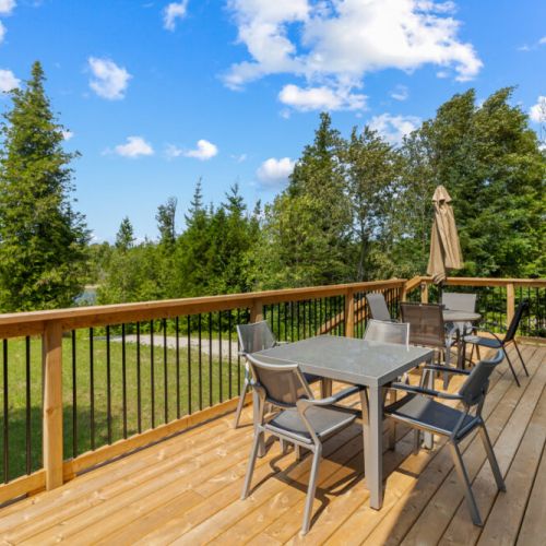 Dine outdoors on the spacious wraparound deck surrounded by nature.
