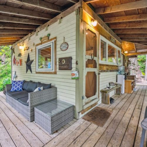 Unwind in the covered outdoor lounge with cozy wicker seating, ambient lighting, and a hammock. Rain or shine, this spot invites you to slow down and breathe in the forest air.