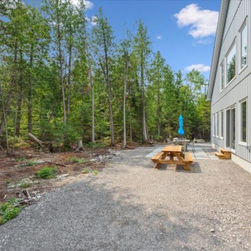 Enjoy meals steps from nature with a picnic table nestled along the forest edge.