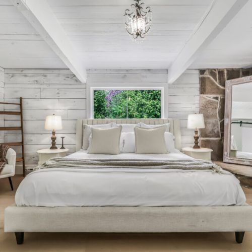 Peaceful primary bedroom with a king bed soft linens and a calming cottage feel.