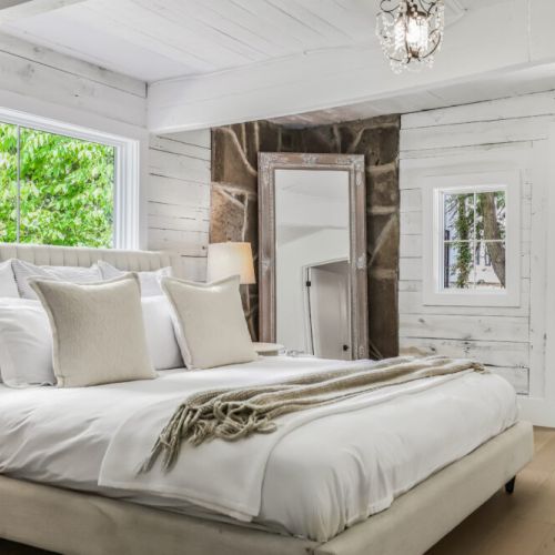 Serene bedroom view with layered bedding and a relaxed modern cottage style.