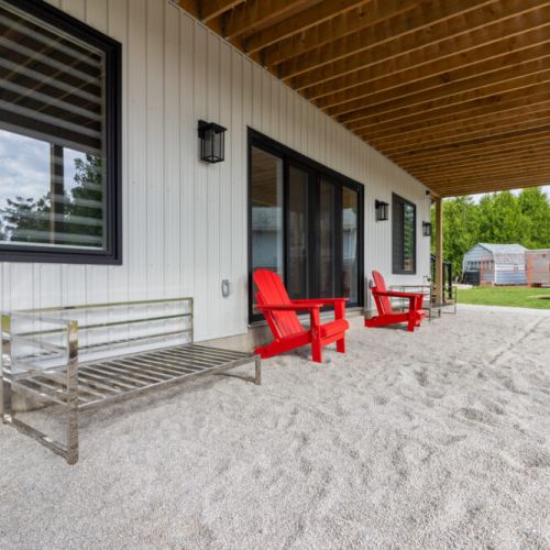 Relax on the covered lower patio just steps from the fire pit and shoreline.