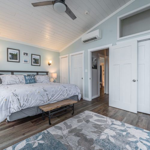 Bedroom 1: Spacious primary suite with calming tones and direct access to ensuite amenities.