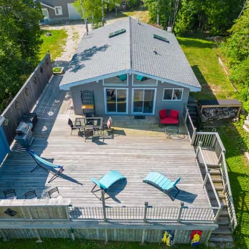 Aerial view of Sunset Cove, showcasing the large wraparound deck and unbeatable lakeside location just minutes from Tobermory.