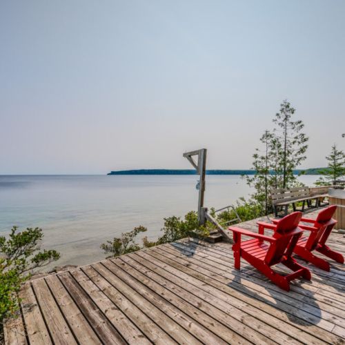 The deck extends right up to the water's edge, offering breathtaking views of Georgian Bay. It's a perfect spot for sunbathing, reading, or simply soaking in the natural beauty.