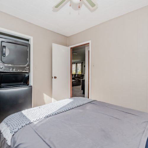 Enjoy added convenience with an in-suite washer and dryer in this relaxing bedroom—perfect for extended family getaways or beachside stays.