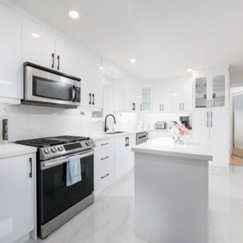 Kitchen with gas stove, microwave, and exit to the second floor BBQ balcony.