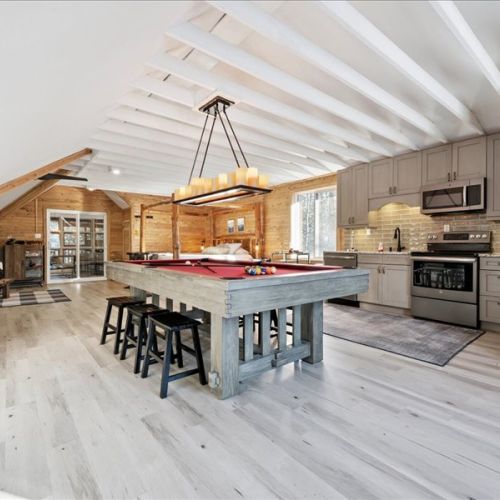 Open-concept loft living with a full kitchen, bar seating, and a pool table at the center of it all. A fun, inviting space for meals, games, and relaxing nights in.