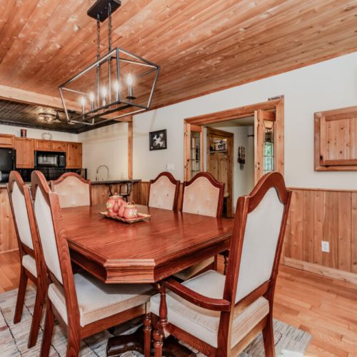 Gather around a large family dining table next to a rustic kitchen—perfect for home-cooked meals on your nature escape.