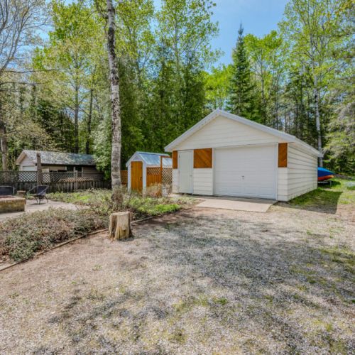 The garage and surrounding backyard offer plenty of space for outdoor activities and parking.