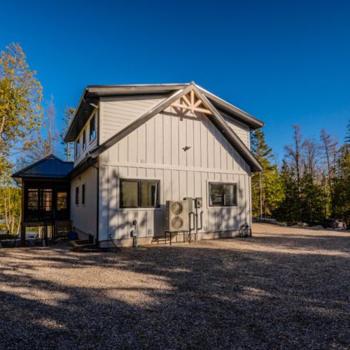 Modern vacation rental nestled in the forest with a screened porch, ample parking, and natural light—perfect for peaceful nature getaways, family stays, or remote work escapes.