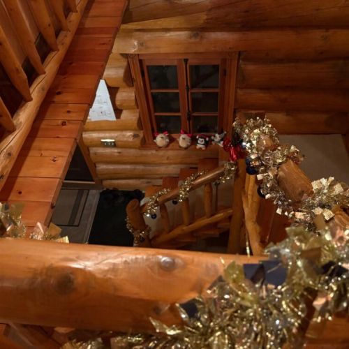Loft view delights, looking down on a staircase wrapped in festive warmth