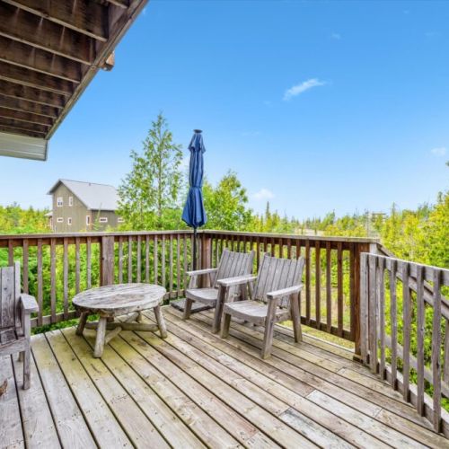 Relax on the elevated deck with forest views and rustic Adirondack seating—ideal for morning coffee or evening sunsets.