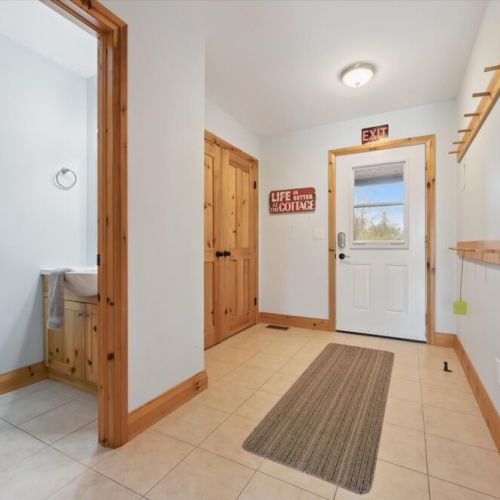The entryway provides a welcoming arrival space with convenient storage for coats and gear.