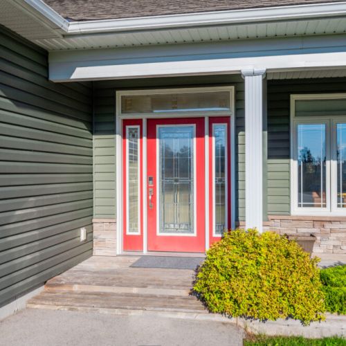 A vibrant red door welcomes you to this stylish, well-maintained cottage—inviting charm from the moment you arrive.