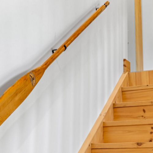 Warm wood accents throughout the staircase add to the cottage's inviting charm.