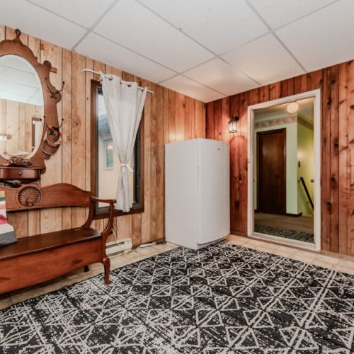 This convenient entry area includes coat hooks, bench seating, and an extra freezer for longer stays or storing your fresh market finds.